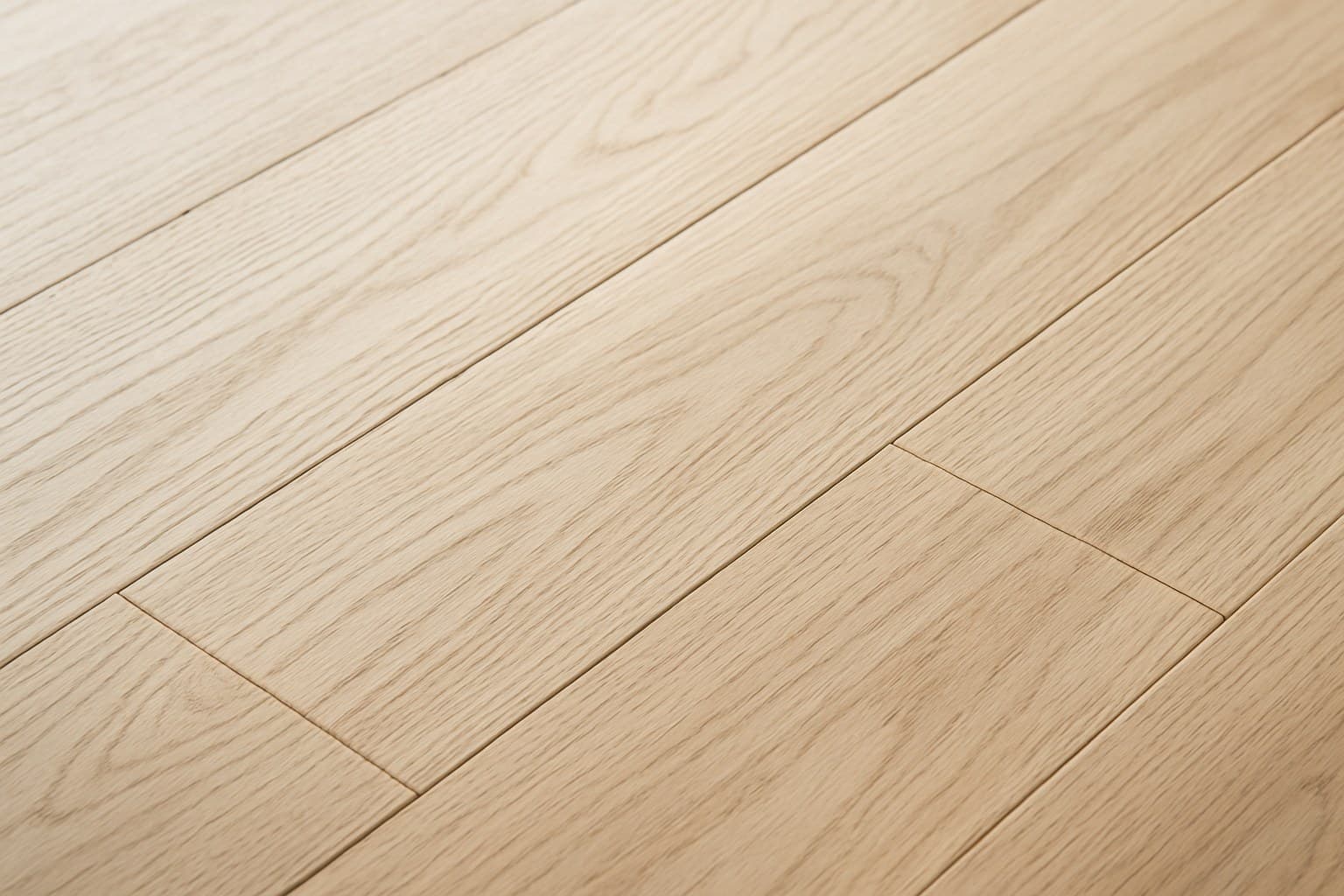 Detailed grain and undertone of a light blonde wood floor plank