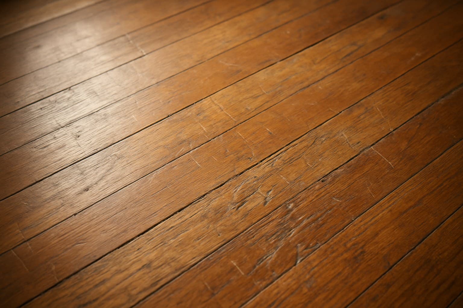 Scratched and worn hardwood floor boards needing repair