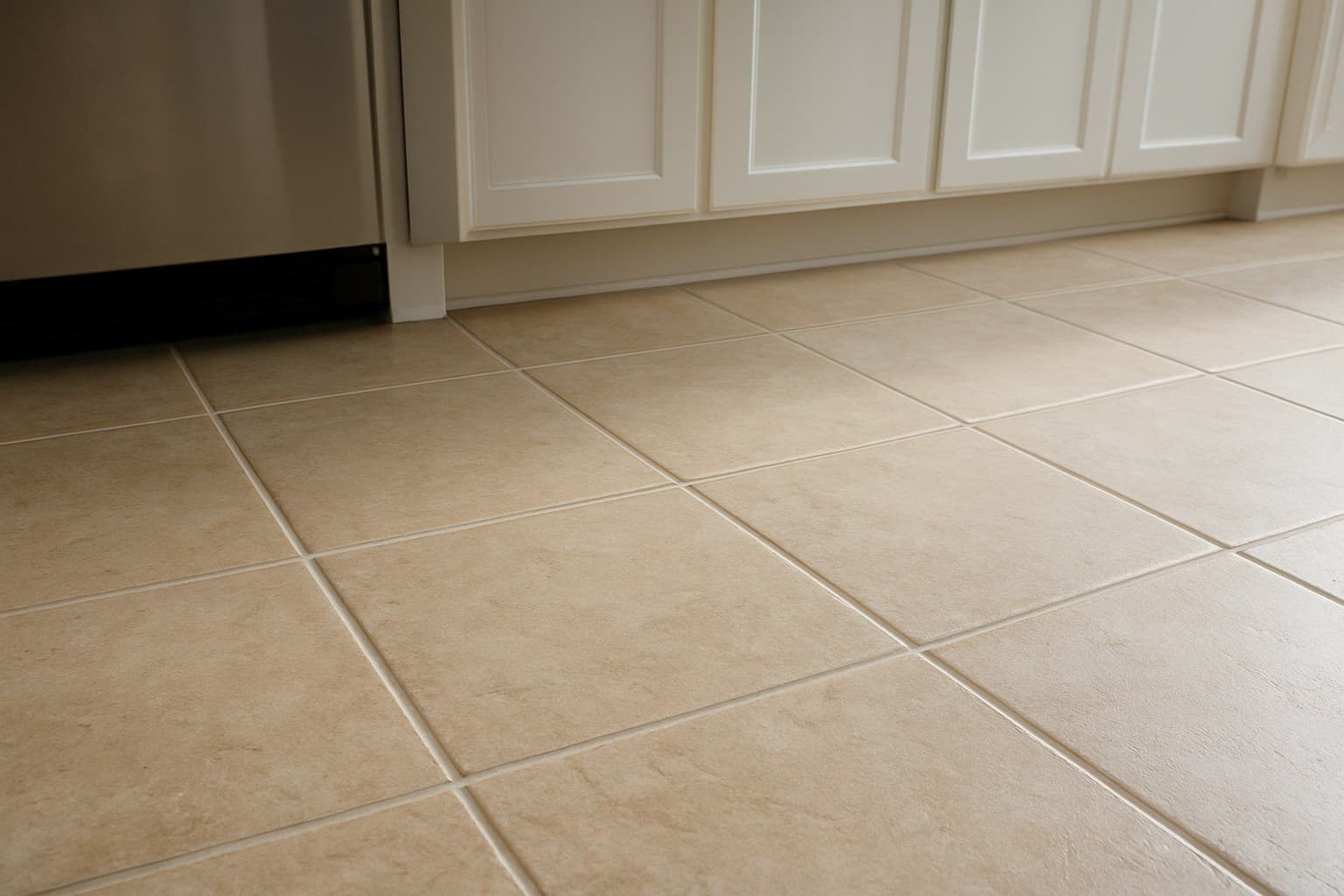 Close-up of tile flooring in a kitchen showing grout lines and hard surface