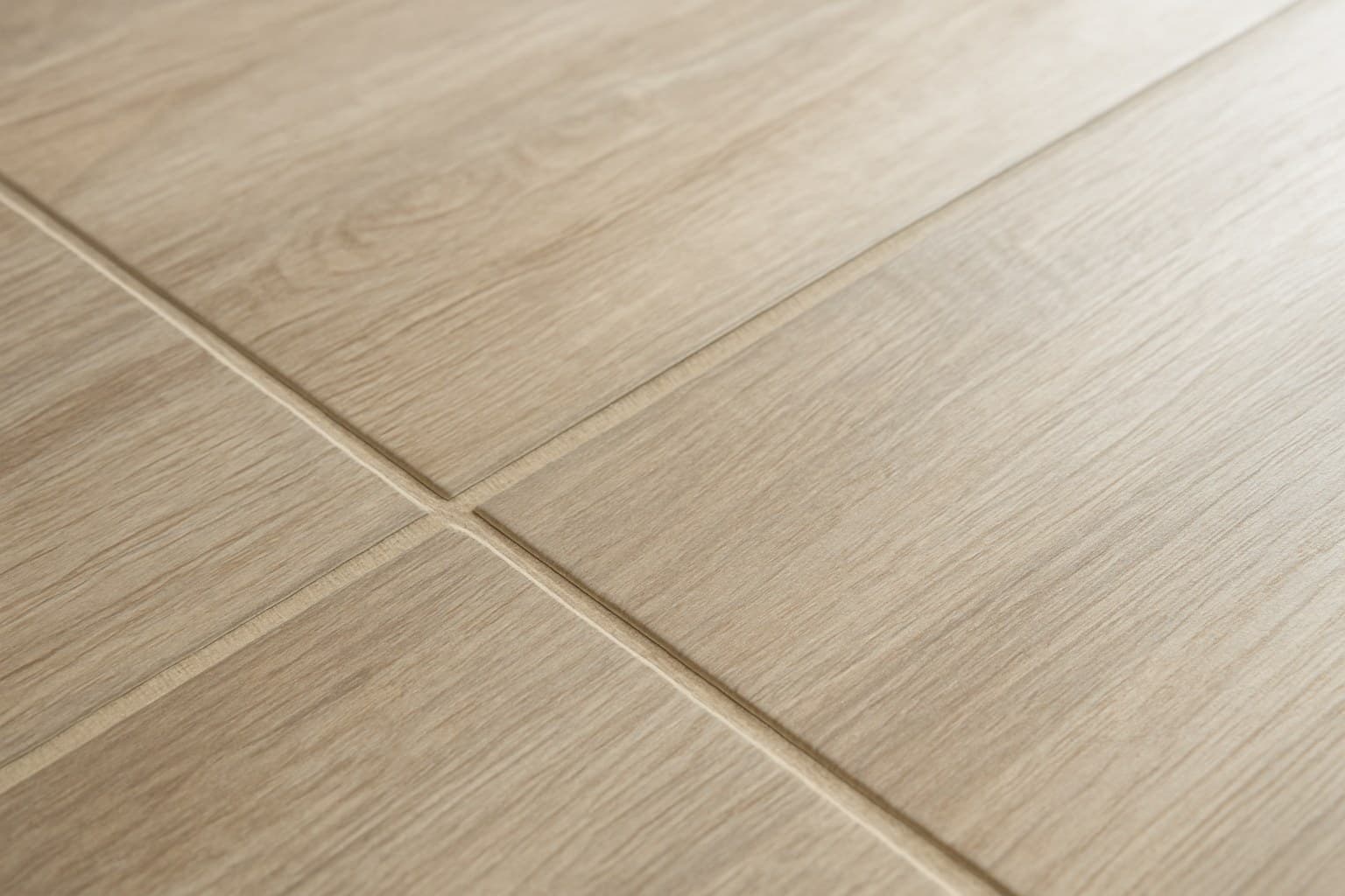 Close-up of a faux grout line between laminate tile-look planks