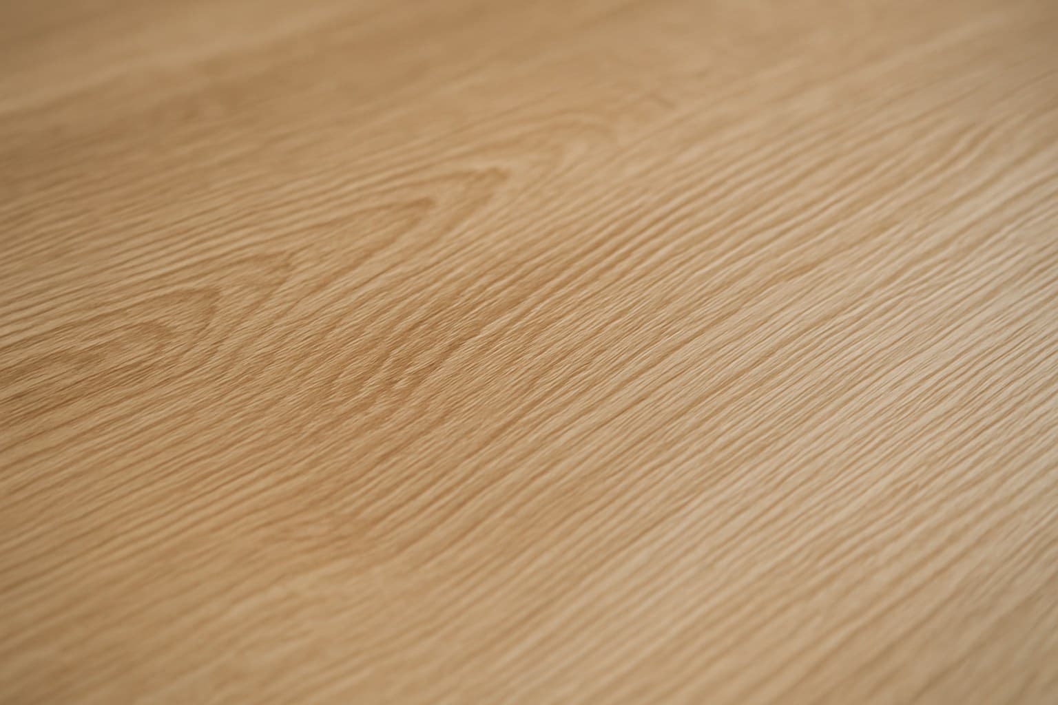 Close-up of embossed wood grain texture on a vinyl plank surface
